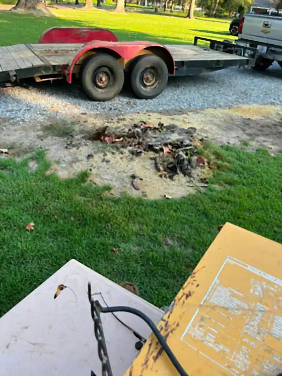 Pickup truck and equipment trailer on a gravel drive