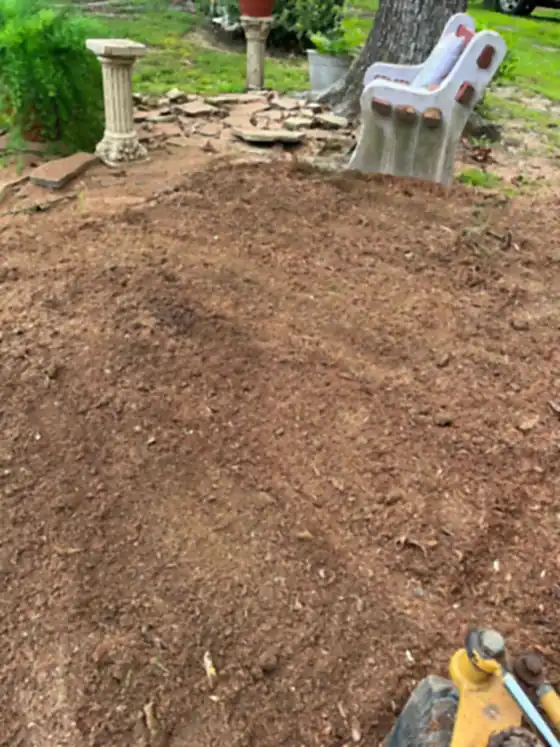 Grindings raked back beside garden ornaments and lawn chairs